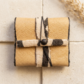 Sand & Mud leather wallet in a warm boutique setting